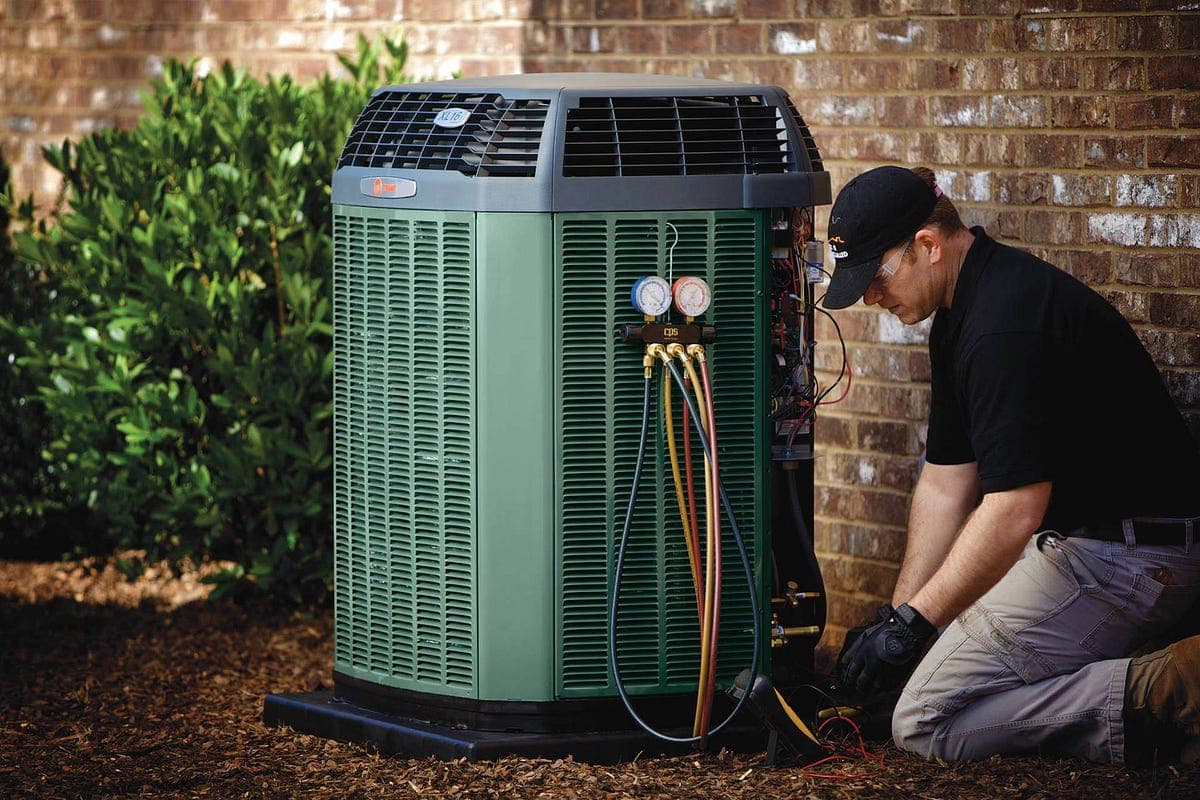Air Factory technician servicing an air conditioner in Nichols Hills, Oklahoma